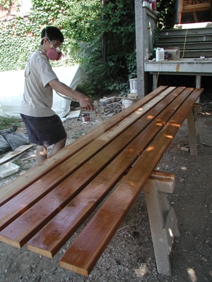 exterior stain applying with sprayer